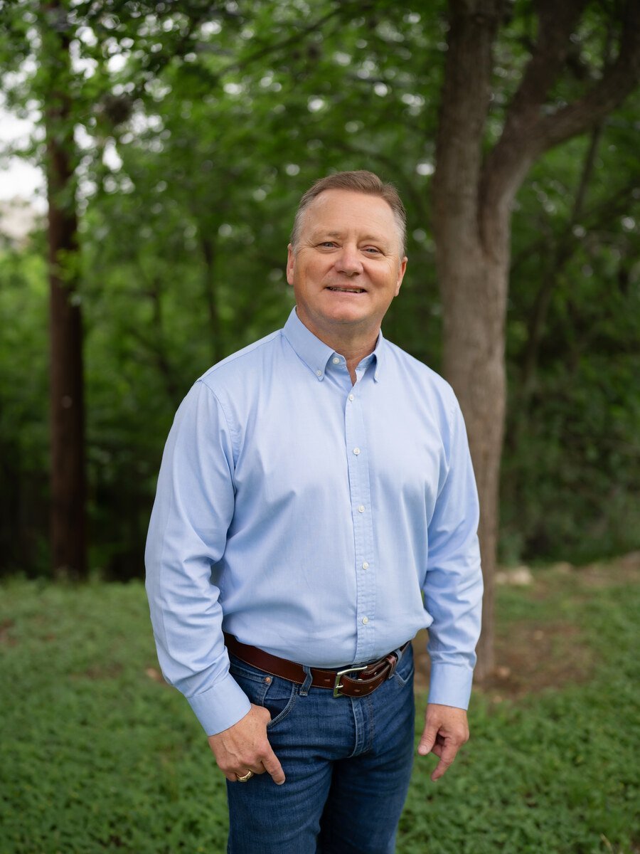 Portrait of Charles Coulter standing outdoors in a light blue button-up shirt